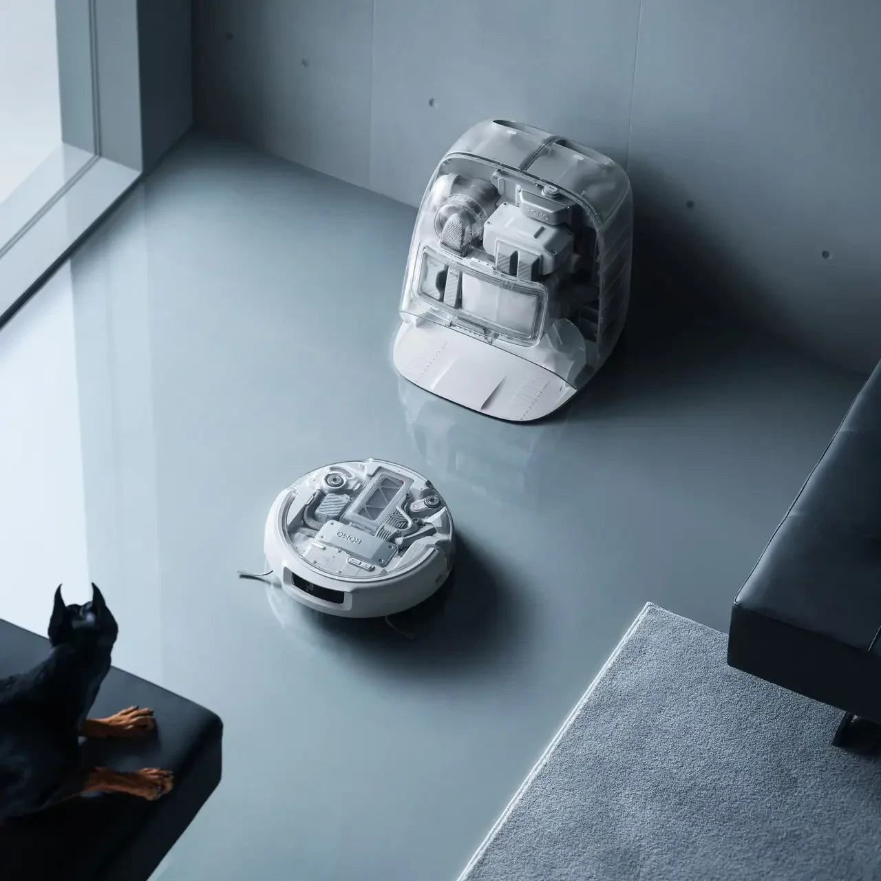 DJI ROMO P Robot Vacuum Cleaner with Transparent Self-Cleaning Base Station, featuring minimalist aesthetic design, drone-powered obstacle sensing, and high-pressure cleaning for home floor care
